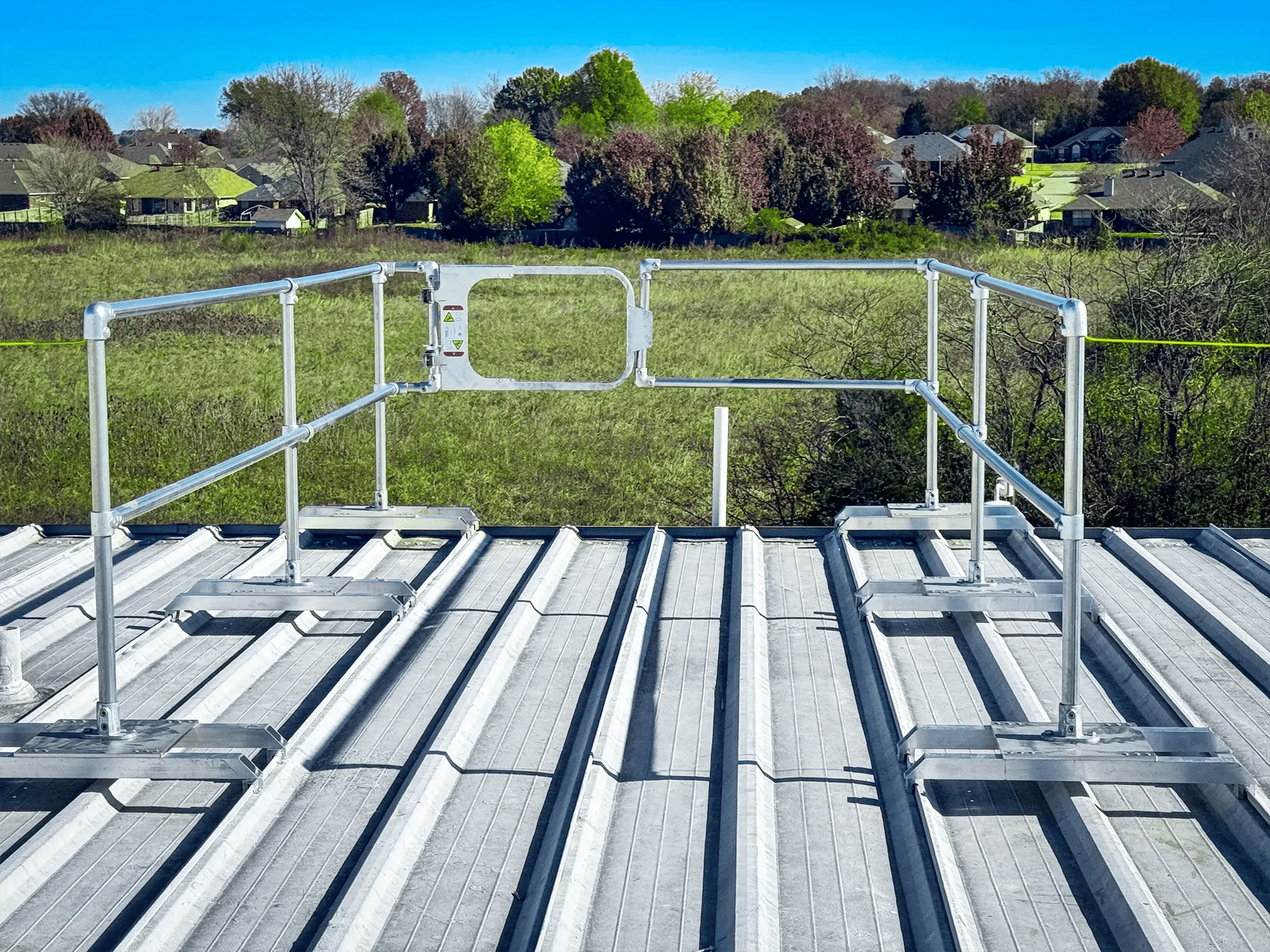A component guardrail fall protection system on a standing seam roof A component guardrail fall protection system on a standing seam roof