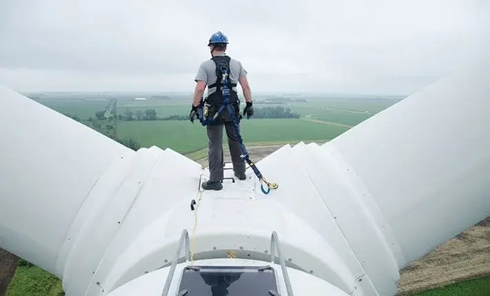 worker on wind turbine attached to anchor