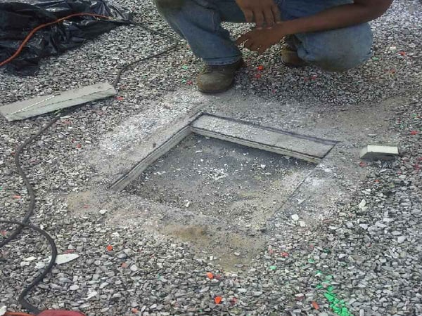 installation photo of hole in rooftop to install rigid anchor post