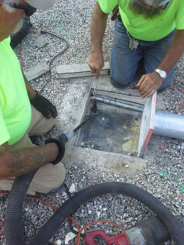 installation workers deepening hole