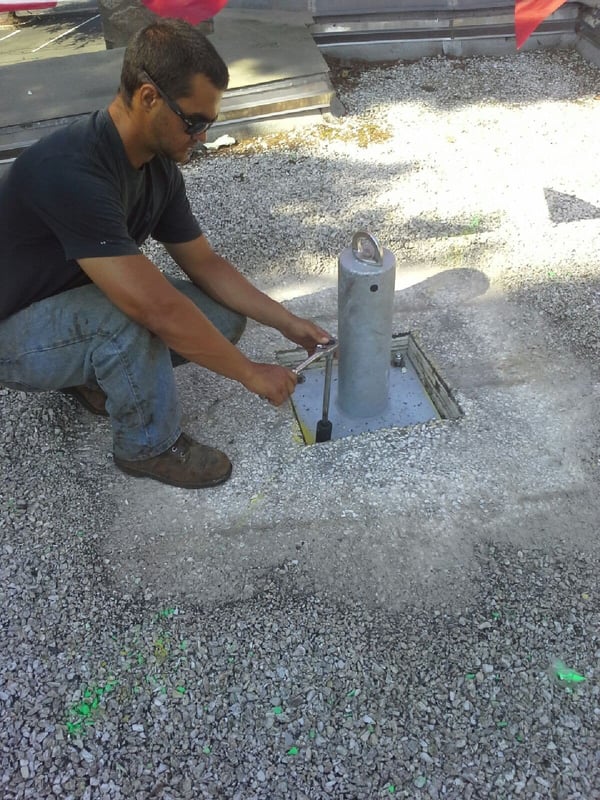 installation worker finishing installing rigid post