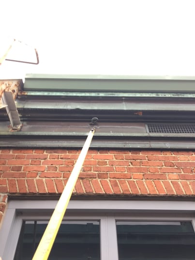 a deformed eyebolt on a brick building