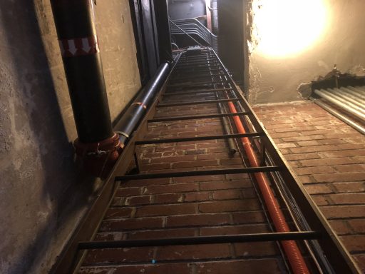 Access ladder with permanently installed fixtures reducing the 7-inch minimum offset required by OSHA, rendering the installation noncompliant.